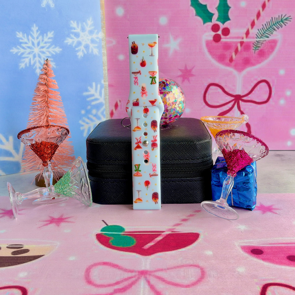 Single buckled Holiday Spirits, Please? Samsung watch band strap standing on a jewelry box between martini glasses