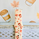 Close view of the Falling in Love a Latte Samsung Galaxy Watch band showing the pale pumpkins, blush maple leaves and dainty bows on cream silicone.