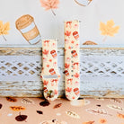 Falling in Love a Latte Samsung Galaxy Watch band shown in both size options on a white bench, cream coffee and pumpkin print.