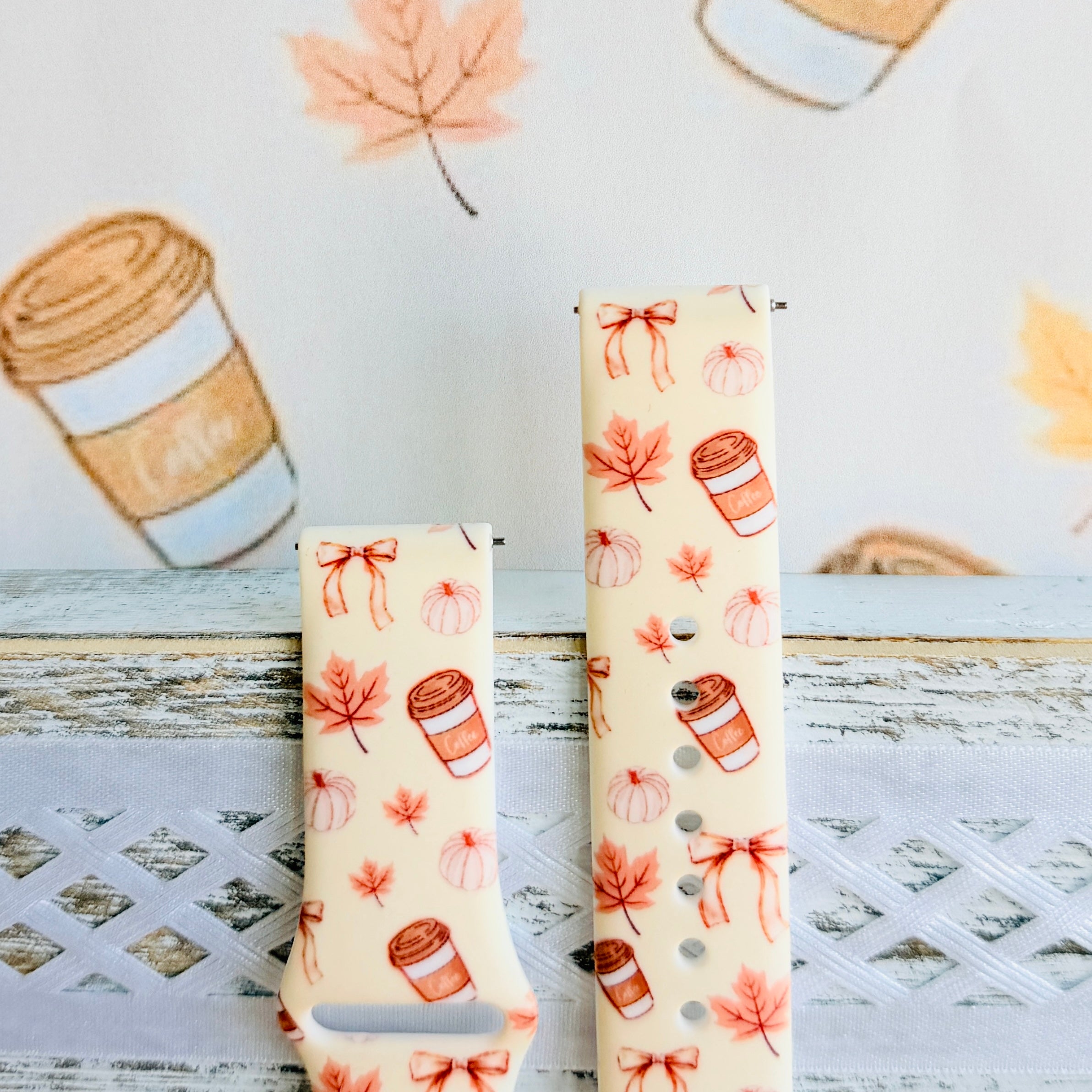 Both sizes of the Falling in Love a Latte Samsung Galaxy Watch band side by side, close view of the cream print with coffee cups and rust bows.