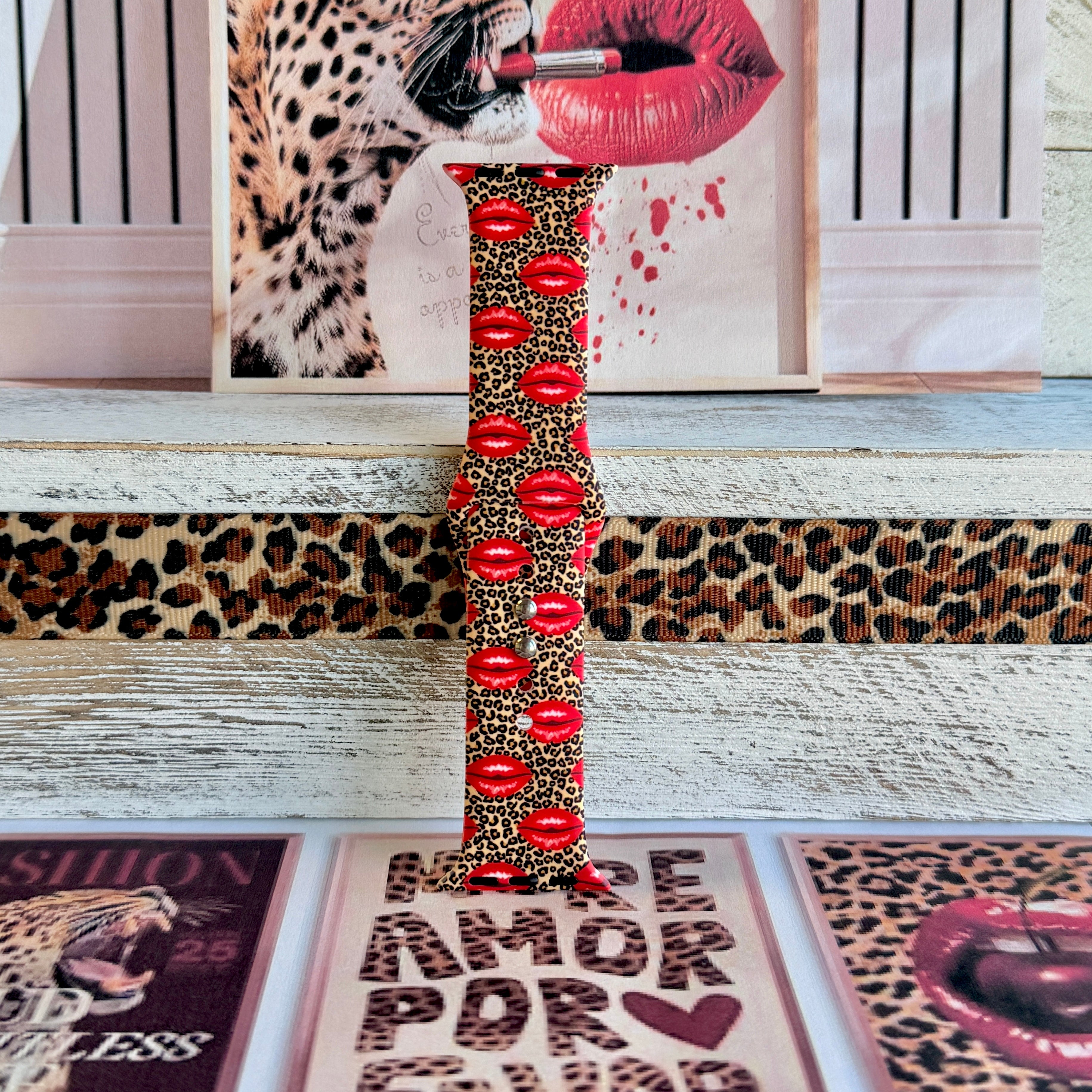 Kiss Me Leopard Apple Watch band with red glossy lips on tan leopard print styled with beauty and fashion decor
