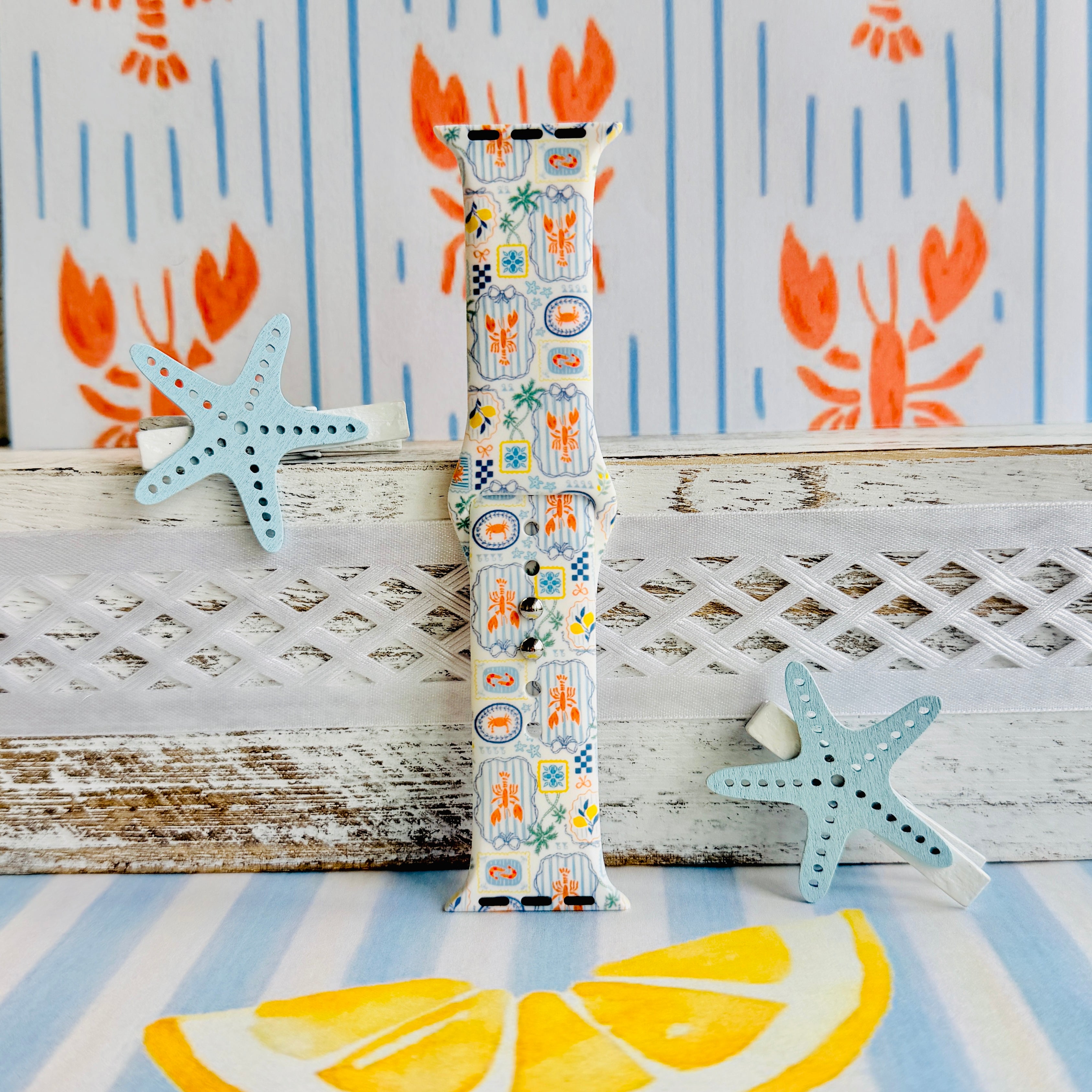 Coastal Catch Apple Watch band with orange lobsters, blue crabs, and yellow lemons on gray background with starfish decorations
