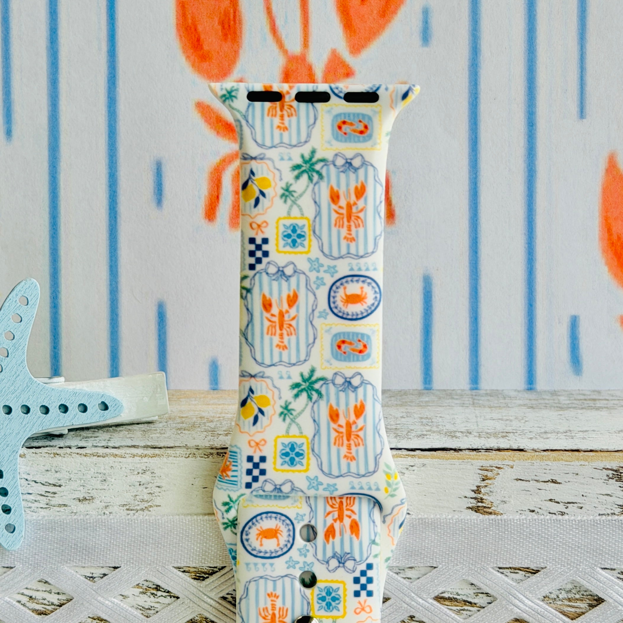 Coastal Catch Apple Watch band with orange lobsters, blue crabs, and yellow lemons on gray background with starfish decorations
