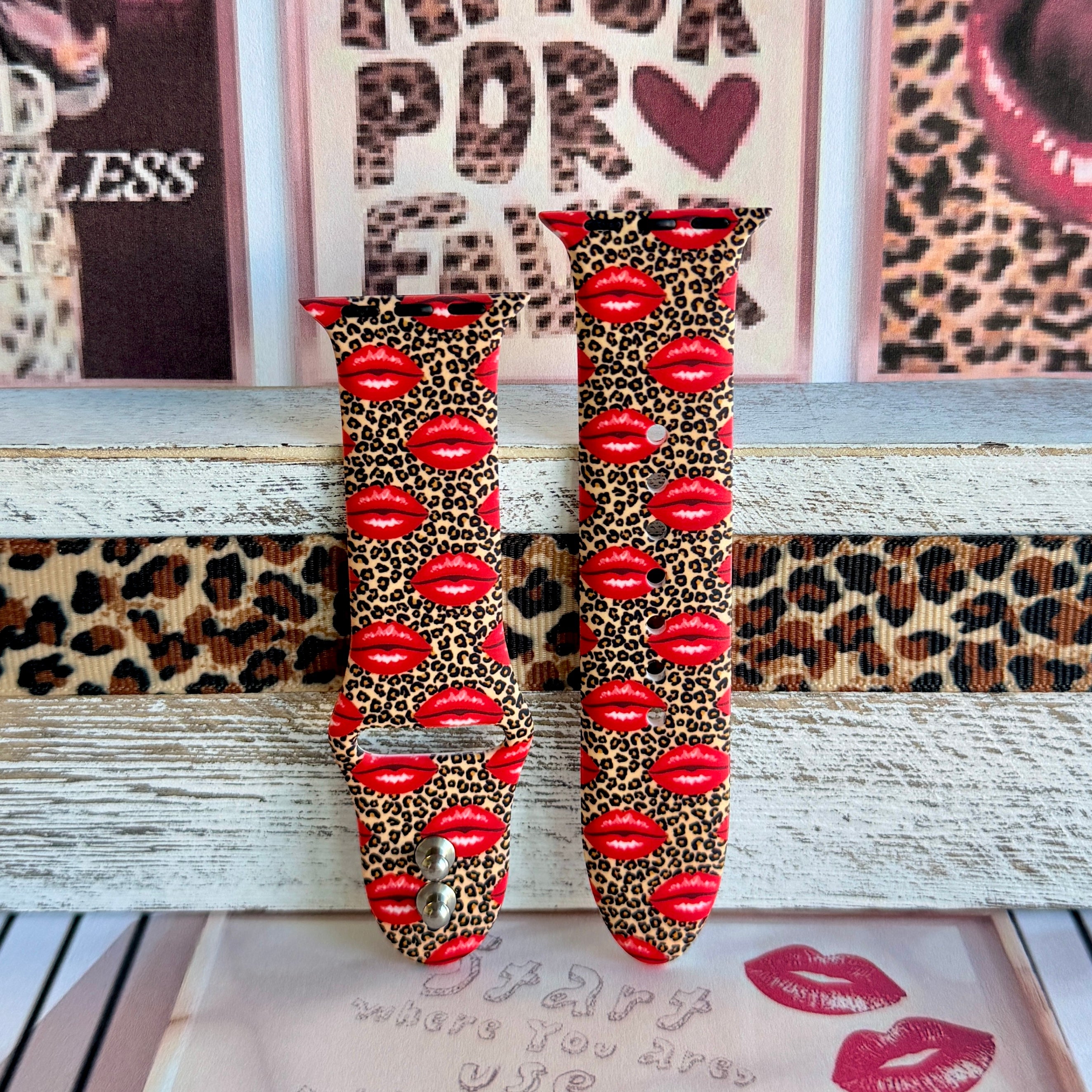 Kiss Me Leopard Apple Watch band with red glossy lips on tan leopard print styled with beauty and fashion decor
