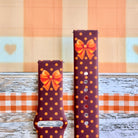 Spotted Looking Cute Samsung Galaxy Watch band front view of both strap halves, showing the orange bow near the top of each half and the quick-release pin holes.