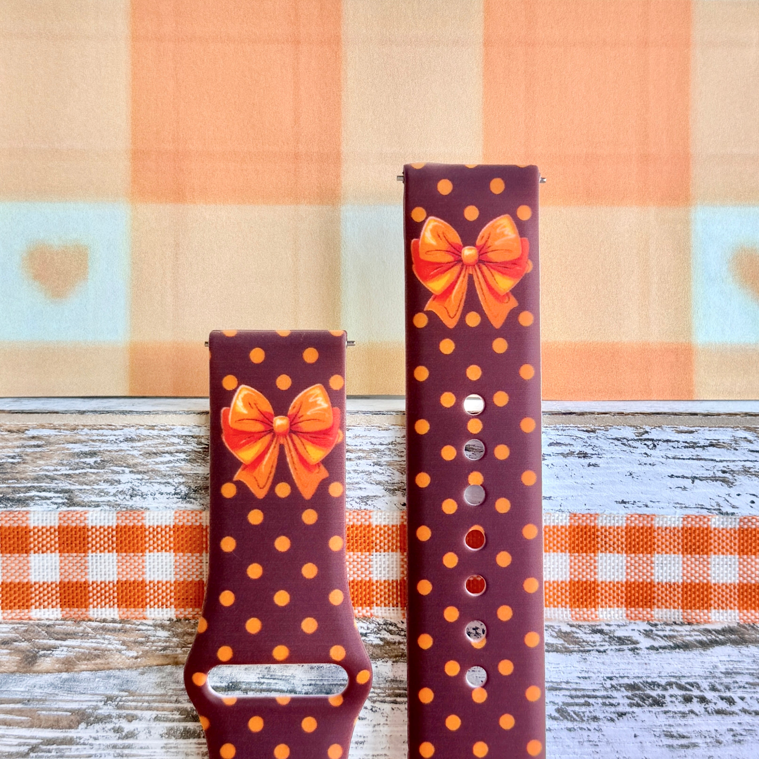 Spotted Looking Cute Samsung Galaxy Watch band front view of both strap halves, showing the orange bow near the top of each half and the quick-release pin holes.