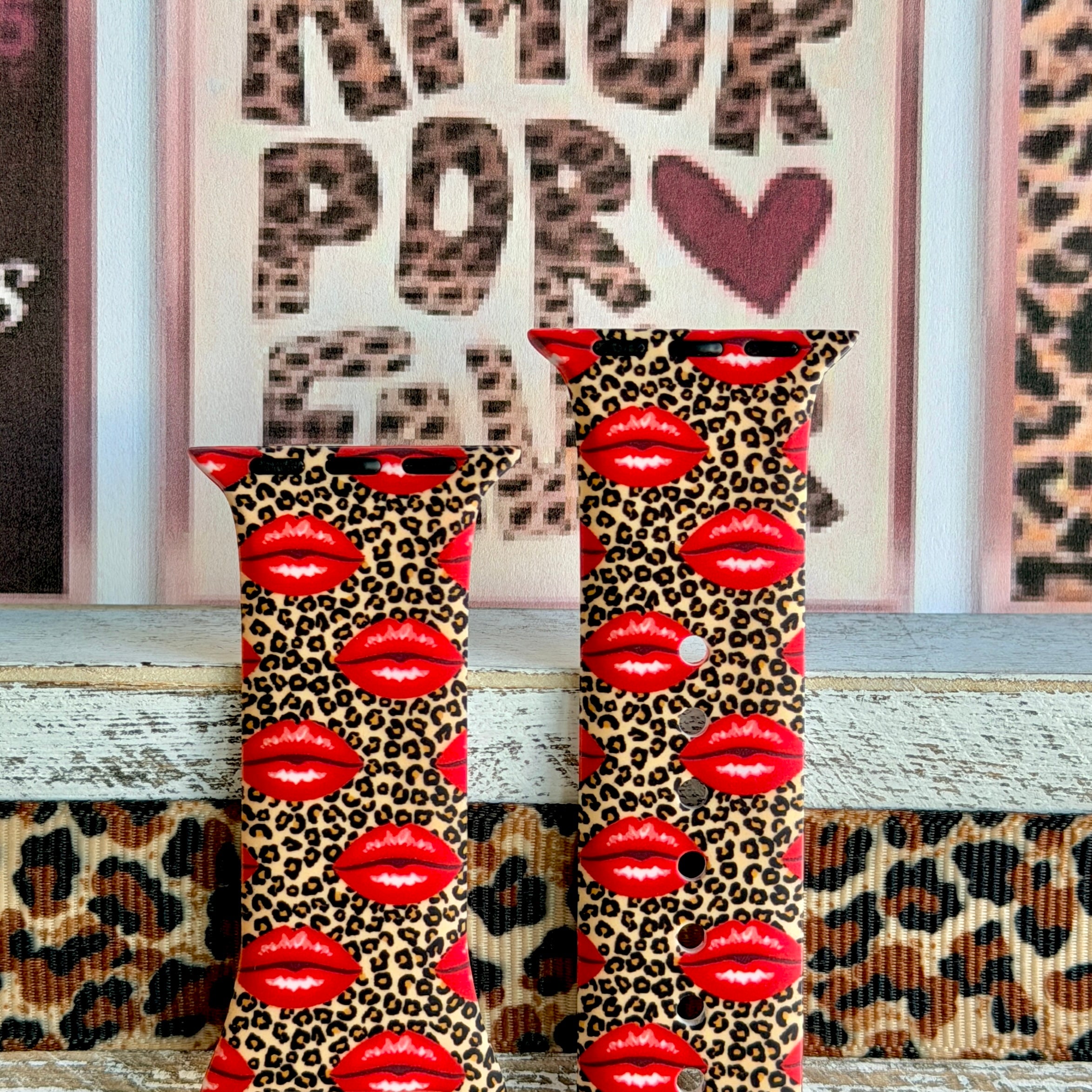 Kiss Me Leopard Apple Watch band with red glossy lips on tan leopard print styled with beauty and fashion decor
