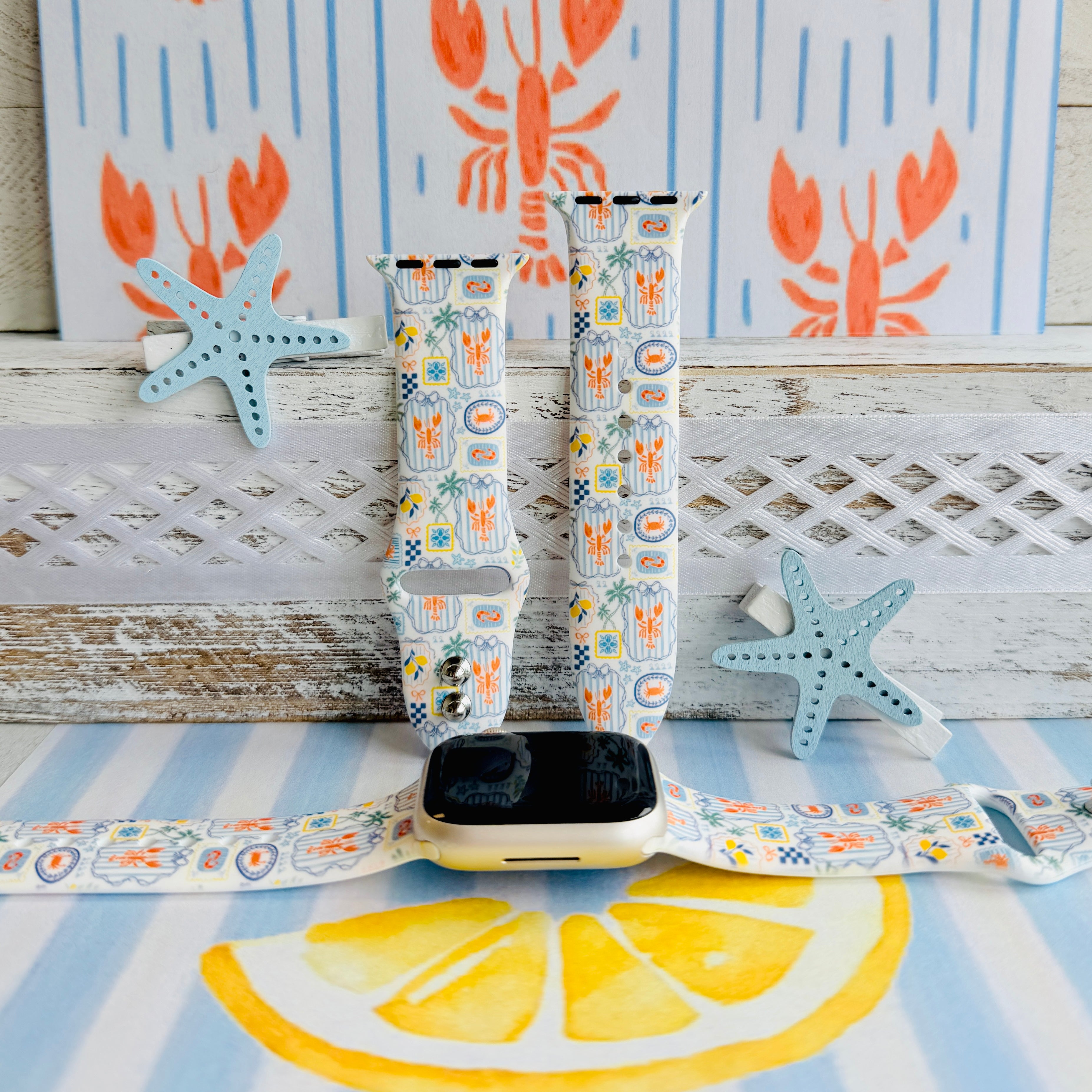 Coastal Catch Apple Watch band with orange lobsters, blue crabs, and yellow lemons on gray background with starfish decorations

