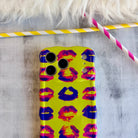 Neon yellow wavy iPhone case featuring a pattern of blue, pink, and red kiss lips in a pop-art style.