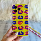Neon yellow wavy iPhone case featuring a pattern of blue, pink, and red kiss lips in a pop-art style.