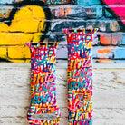 Love Riot Apple Watch band with colorful graffiti "LOVE" text in red, pink, yellow, blue, and turquoise with street art backdrop
