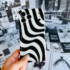 Wavy iPhone case featuring a bold black and white swirly striped pattern with a high-gloss finish.
