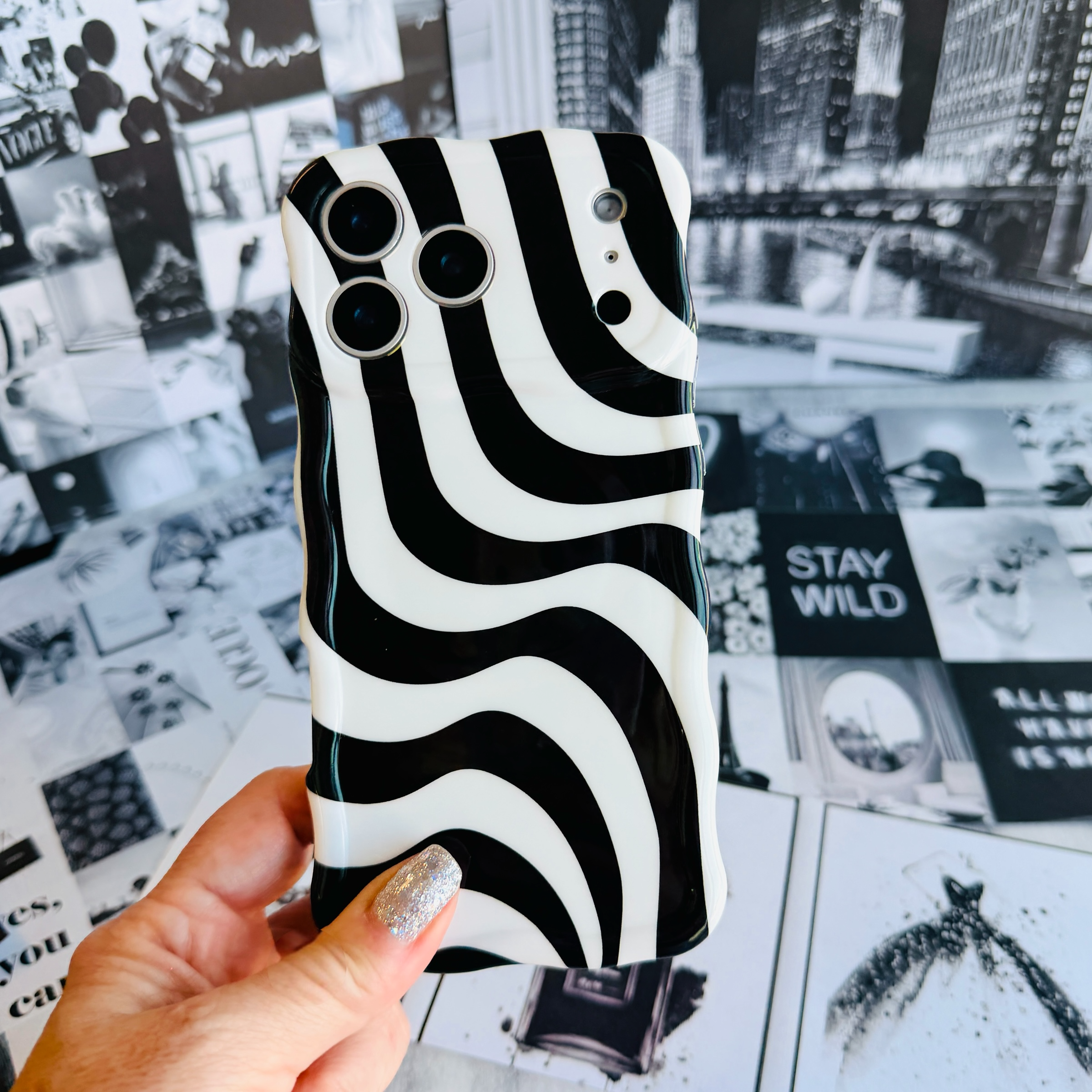 Wavy iPhone case featuring a bold black and white swirly striped pattern with a high-gloss finish.