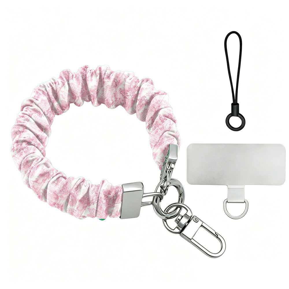 Blush Manor Scrunchie Phone Wrist Strap shown with its silver lobster clasp, black loop cord and phone attachment tab, gathered pink toile fabric.
