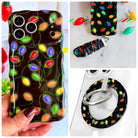 Christmas Lights iPhone Matching Set - black MagSafe case with glowing multicolor Christmas bulbs, matching Hold It Fancy grip ring and scrunchie phone wrist strap from Fancy Bands
