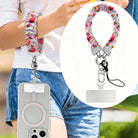 Berry Cute Blooms Scrunchie Phone Wrist Strap worn on the wrist with the phone at the hip, plus a close-up of the strawberry and daisy print and clasp.