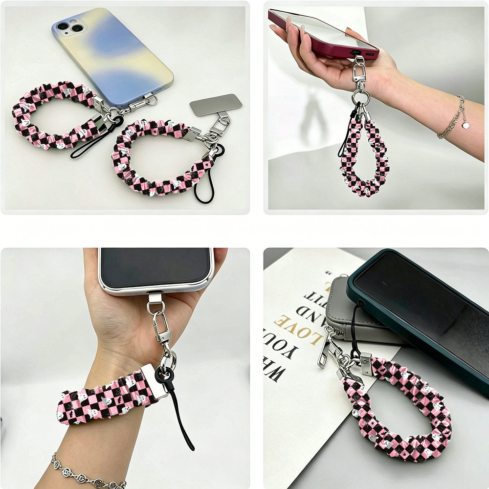 Four views of the Hey Boo, Looking Cute Scrunchie Phone Wrist Strap clipped to a phone case, held in the hand, worn on the wrist and resting on a book.