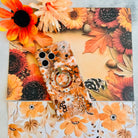 Fall Blooms Hold It Fancy MagSafe grip ring with a warm autumn floral print, shown with the matching iPhone case