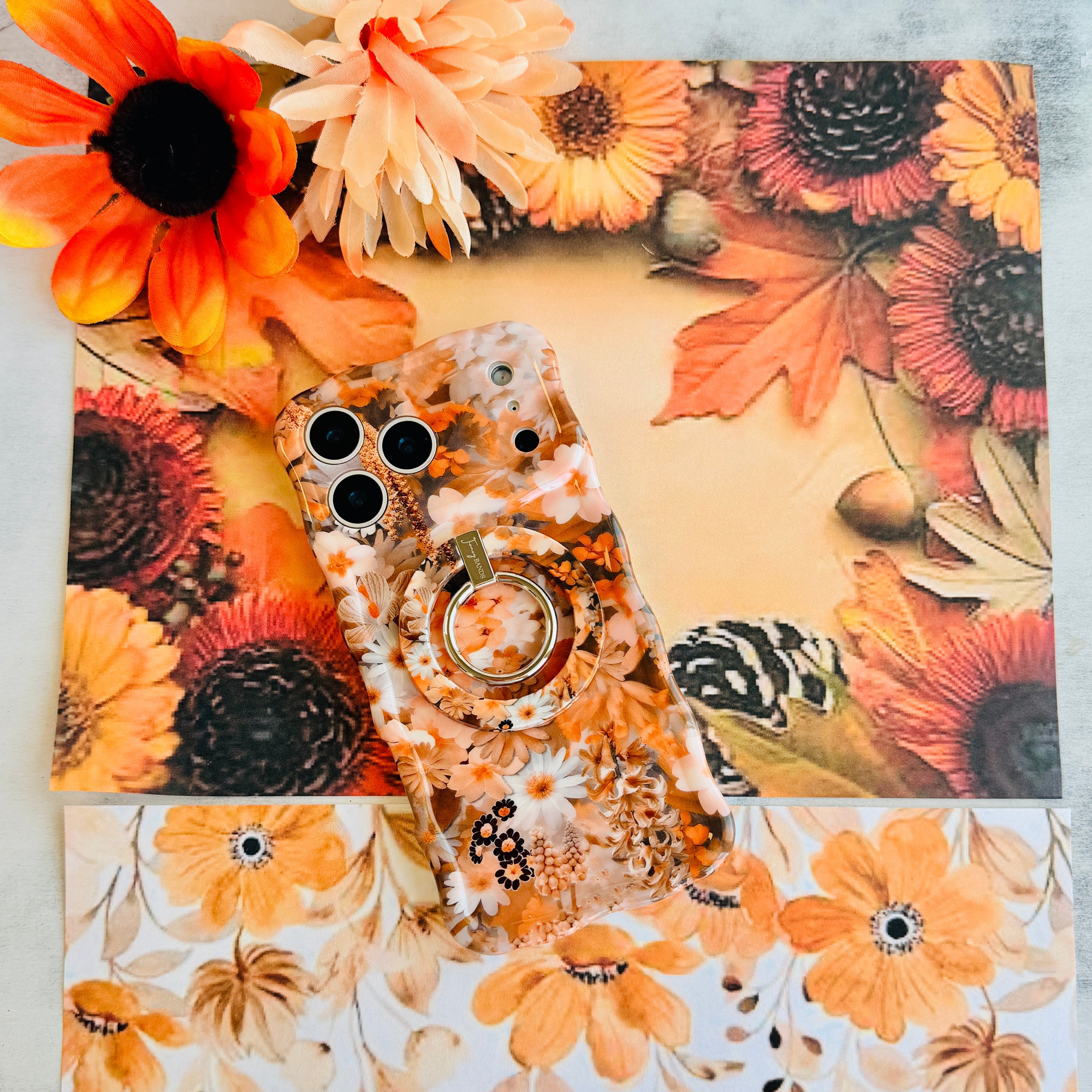 Fall Blooms Hold It Fancy MagSafe grip ring with a warm autumn floral print, shown with the matching iPhone case