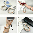 Fall Blooms autumn floral scrunchie phone wrist strap in orange and cream with silver clasp and phone attachment tab