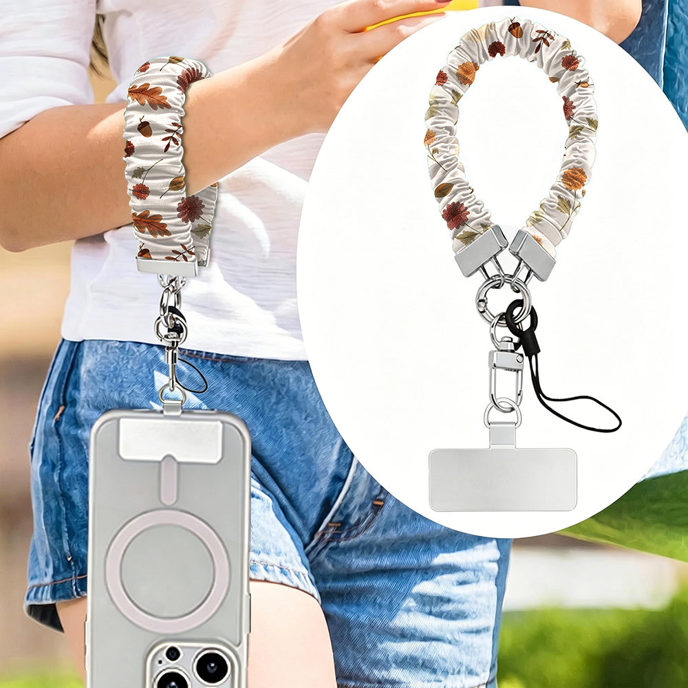 Fall Floral Bliss scrunchie phone wrist strap worn on the wrist, with a close-up of the cream floral strap, silver clasp and attachment tab