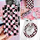 Hey Boo, Looking Cute iPhone Matching Set: hand-held pink and black checkerboard MagSafe case with white ghosts, matching scrunchie wrist strap, and MagSafe grip ring