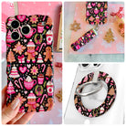Merry Mugs and Ginger Hugs iPhone Matching Set - black gingerbread and pink cocoa print MagSafe case, matching Hold It Fancy grip ring and scrunchie phone wrist strap from Fancy Bands