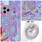 No Peeking, Darling iPhone Matching Set - lavender MagSafe case with pastel pink and aqua gift boxes and gold bows, matching Hold It Fancy grip ring and scrunchie phone wrist strap from Fancy Bands