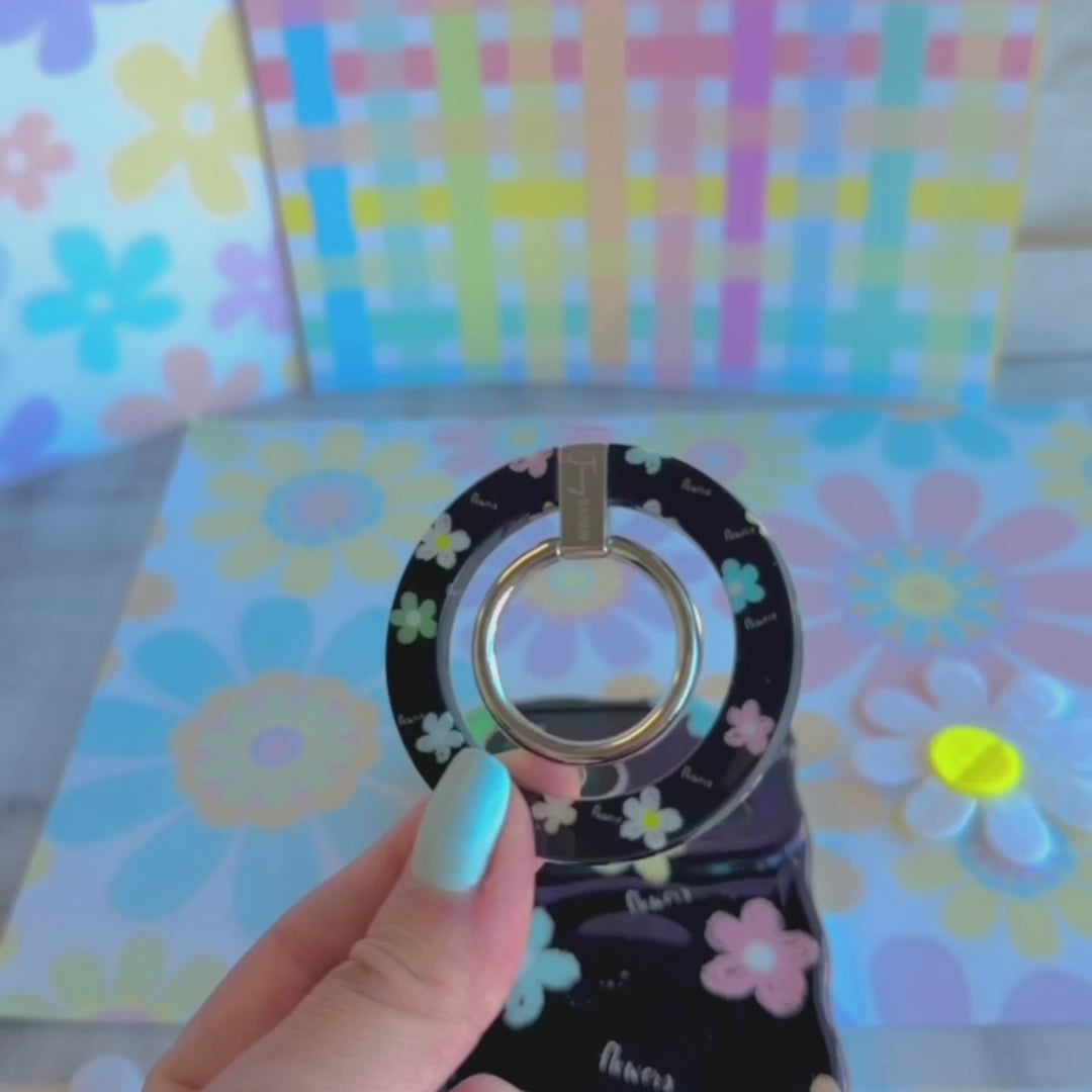 Flower Pop pattern MagSafe phone grip ring with sketched colorful flowers and script text on black background compatible with iPhone and Samsung