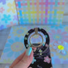 Flower Pop pattern MagSafe phone grip ring with sketched colorful flowers and script text on black background compatible with iPhone and Samsung