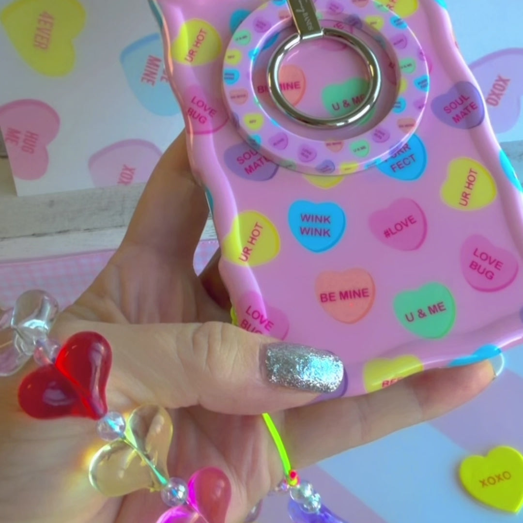 Candy hearts phone charm with translucent rainbow heart beads and crystal accents on conversation hearts phone case
