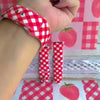 Video of the Red Barn Babe silicone Apple Watch band worn on the wrist and shown in both sizes, red and white gingham on the bias.