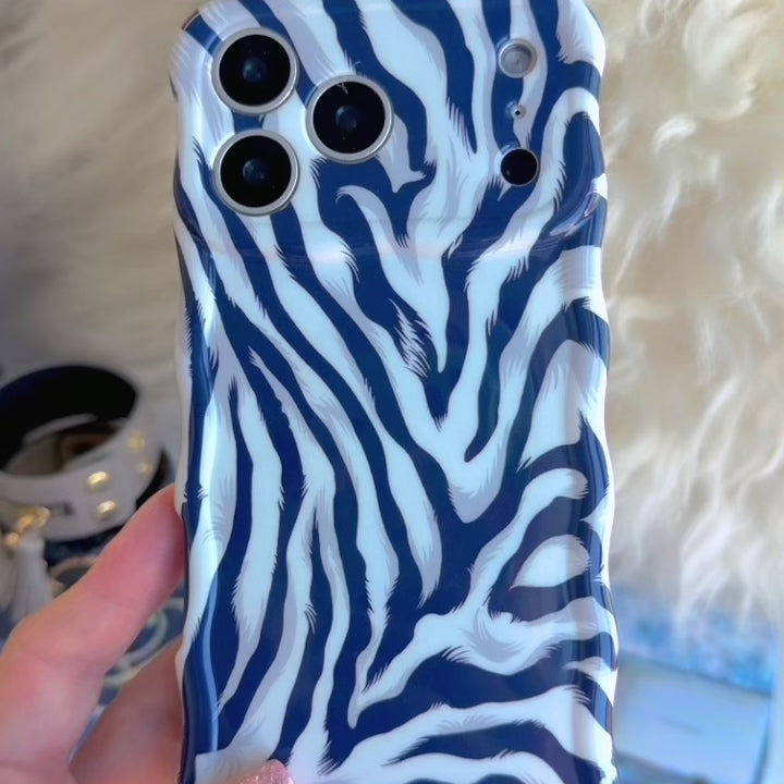 Video turning the Zebra, Obviously Wavy Luxe MagSafe iPhone case in hand to show the navy and white zebra print wrapping over the high-gloss sculpted wavy edges.