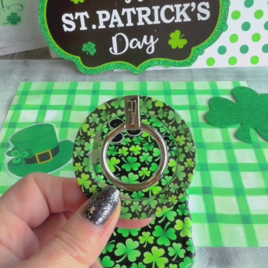 Shamrock pattern MagSafe phone grip ring with green clovers on a black background compatible with iPhone and Samsung