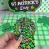 Shamrock pattern MagSafe phone grip ring with green clovers on a black background compatible with iPhone and Samsung