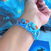 Video of The Bewitching Hour silicone Samsung Galaxy Watch band worn on the wrist with a round Samsung watch and shown in both sizes, light blue Halloween print.