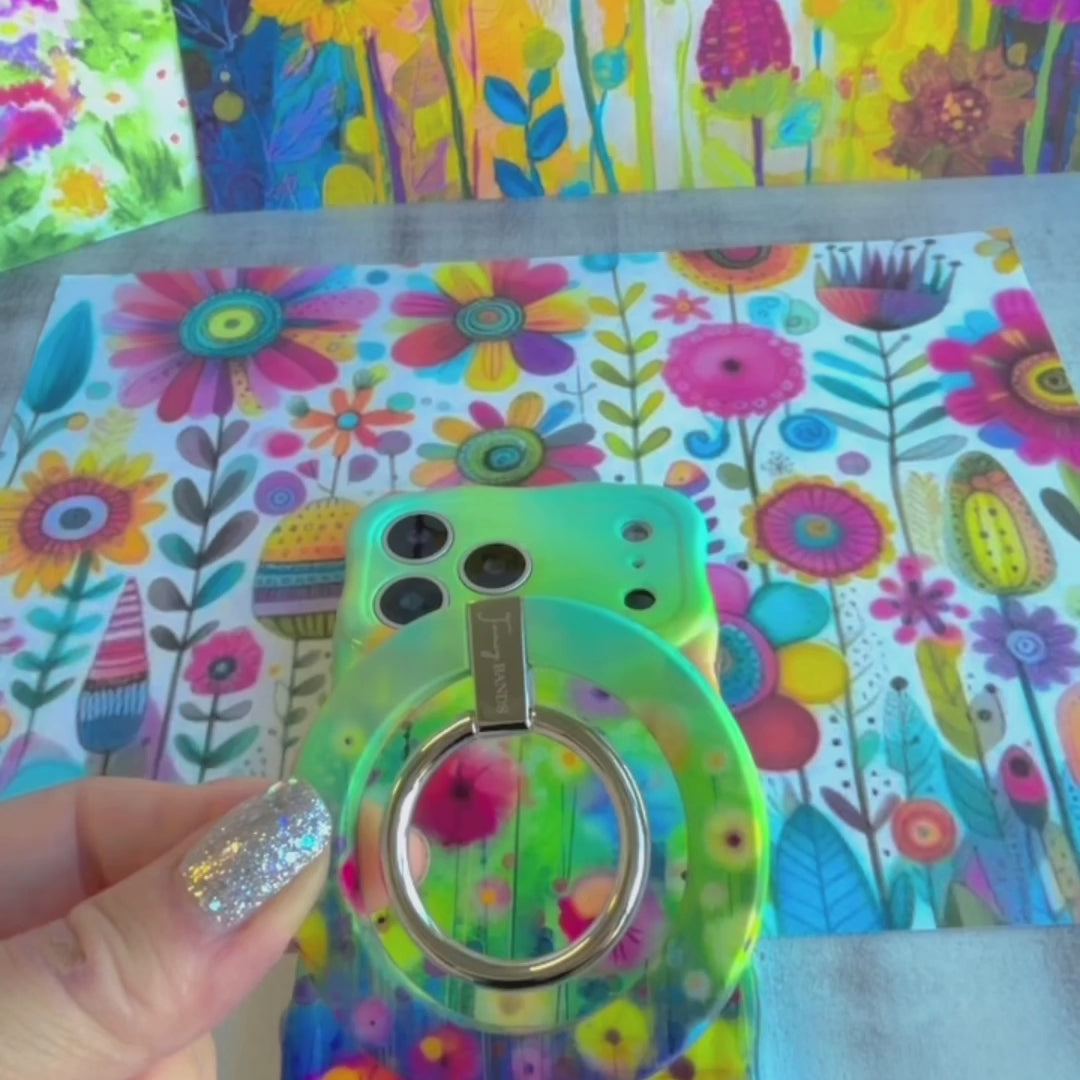 Petal Princess watercolor floral MagSafe phone grip ring with vibrant pink and yellow blooms on green background compatible with iPhone and Samsung