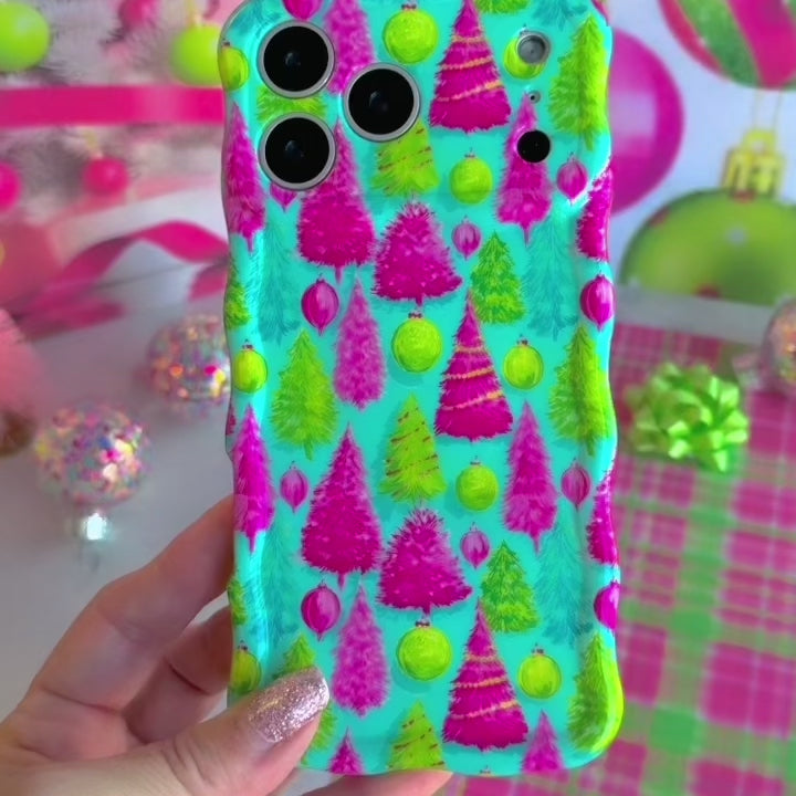 Video: turning the Merry & Bright, Totally! Wavy Luxe iPhone case in hand to show the pink and lime Christmas tree print and glossy wavy edges