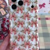 Video: turning the Deck Yourself in Bows & Holly Wavy Luxe iPhone case in hand to show the ribbon bow print and glossy wavy edges