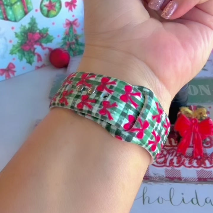 Video: Plaid Tidings & Bows Apple Watch band worn on the wrist, then both gingham bow straps shown on a black jewelry box