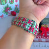 Video: Plaid Tidings & Bows Apple Watch band worn on the wrist, then both gingham bow straps shown on a black jewelry box