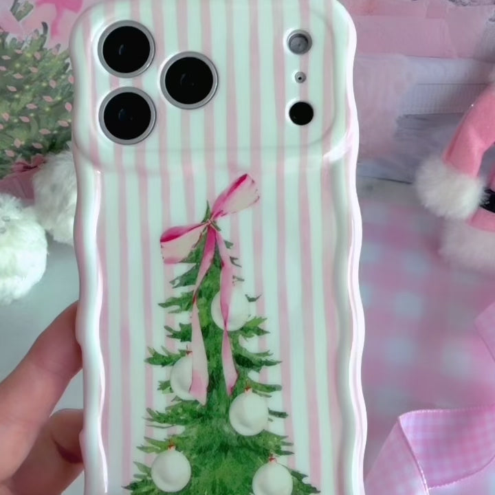 Video: turning the Pretty in PinkMas Wavy Luxe MagSafe iPhone case in hand to show the pink stripes, bow-tied tree and wavy edges
