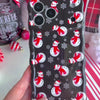 Video: close-up of the Snowman Wavy Luxe MagSafe iPhone case in hand showing the glossy black snowman print and wavy edges