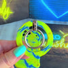 Full Voltage psychedelic marble MagSafe phone grip ring with neon lime green yellow and electric blue liquid swirls compatible with iPhone and Samsung