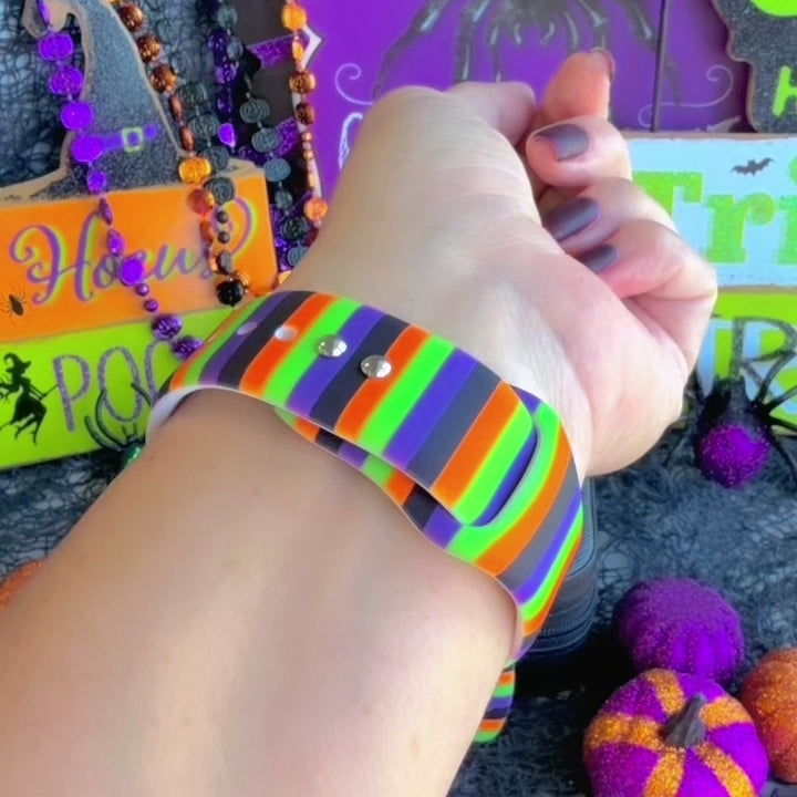 Video of the Main Witch Energy Apple Watch band worn on the wrist, showing the black, purple, green and orange stripes in daily wear.