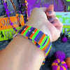 Video of the Main Witch Energy Apple Watch band worn on the wrist, showing the black, purple, green and orange stripes in daily wear.