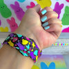 Neon Bunny Bash Apple Watch band with colorful peeps bunnies in pink, purple, yellow, and turquoise on black background
