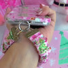 Video: Jolly Pink Santa scrunchie wrist strap worn on the wrist with the matching pink Santa iPhone case hanging from the clasp
