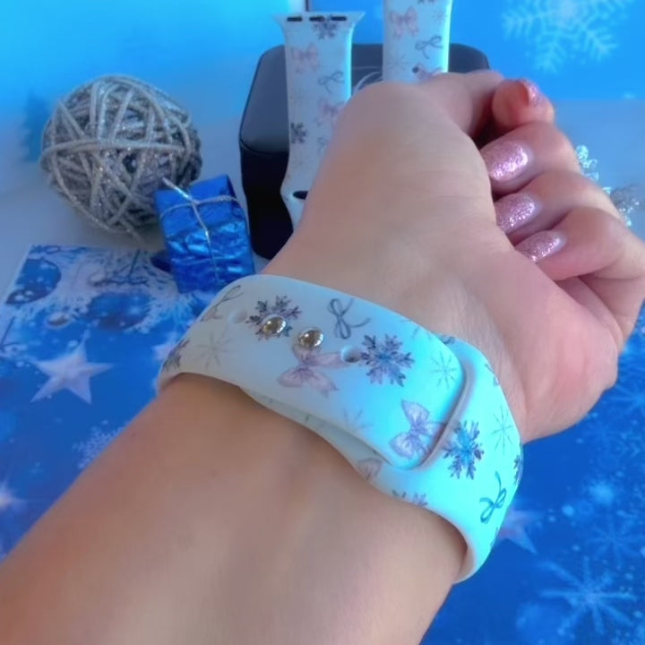Video: Snow Pretty In Blue Apple Watch band worn on the wrist, then both bow and snowflake straps shown on a jewelry box