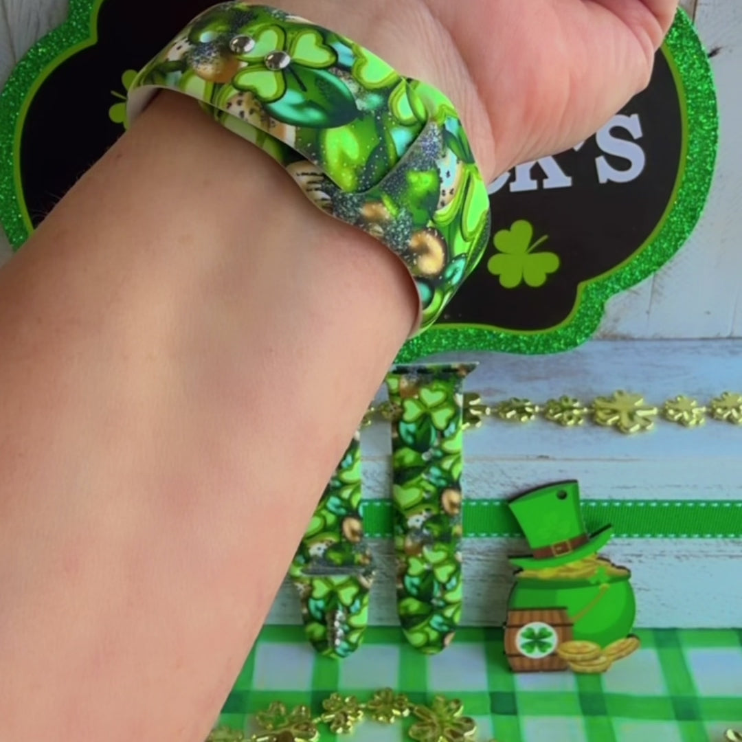 St. Patrick's Day Apple Watch band with green shamrocks, gold coins, and leprechaun hats on festive display
